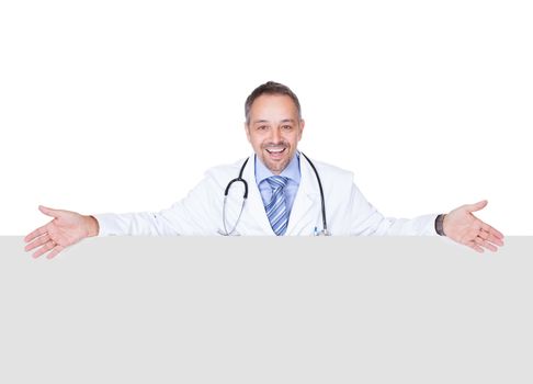 Portrait Of A Doctor Holding Blank Placard Isolated On White Background