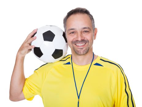 Portrait Of A Happy Man Holding A Soccer Ball On Shoulder Isolated On White Background