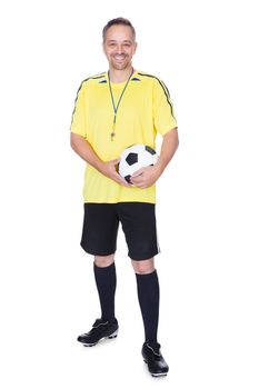 Portrait Of A Happy Soccer Player With A Football Against White Background