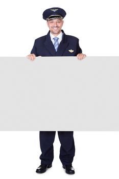 Portrait Of Happy Pilot Holding Blank Placard On White Background