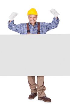 Portrait Of Happy Contractor Holding Placard On White Background