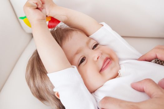 Portrait of a cute innocent young baby smiling and looking with enjoyment