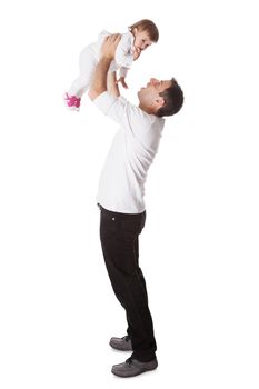 Young father playing with his small baby daughter holding her aloft with his arms extended above his head