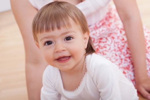 Portrait of a cute innocent young baby smiling and looking with love