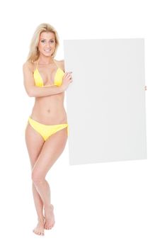 Beautiful young woman in bikini presenting empty board. Isolated on white