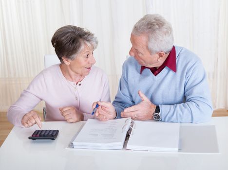 Stressed Senior Couple Calculating Budget At Home