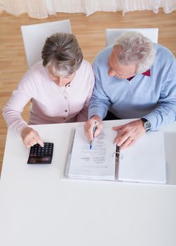 Photo of Senior Couple Calculating Budget At Home