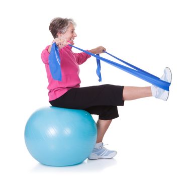 Senior Woman Stretching Exercising Equipment On White Background