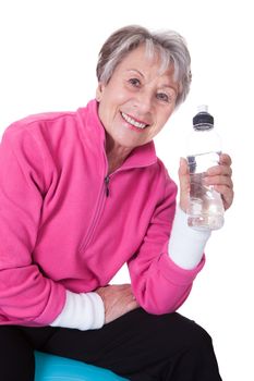 Portrait Of Happy Senior Woman Holding Water Bottle On White Background