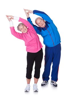 Portrait Of A Senior Couple Exercising On White Background