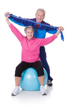 Portrait Of A Senior Couple Exercising On White Background