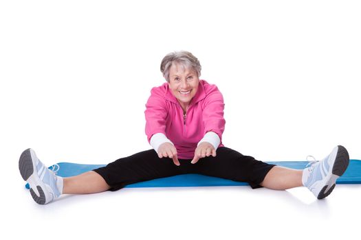 Portrait Of Senior Woman Exercising On White Background