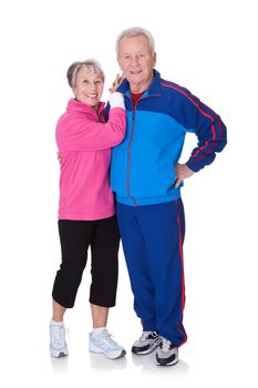 Portrait Of A Senior Couple Exercising On White Background