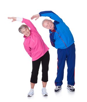 Portrait Of A Senior Couple Exercising On White Background