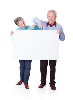 Happy Senior Couple Holding Blank Placard On White Background