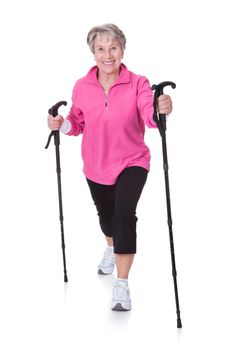Senior Woman Walking With Hiking Poles On White Backgrounds