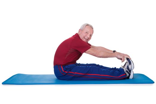 Happy Senior Man Stretching His Legs On White Background