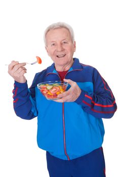 Portrait Of Happy Senior Man Eating Salad On White Background