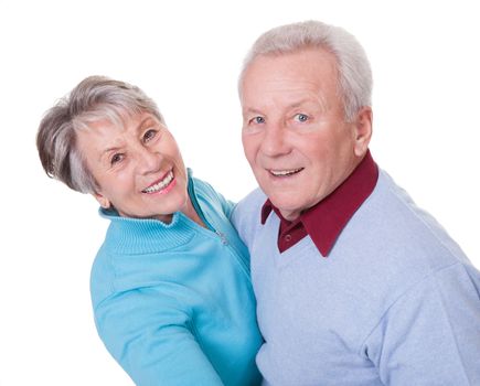 Portrait Of Senior Couple Dancing On White Background