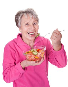 Portrait Of Happy Senior Woman Eating Salad On White Background