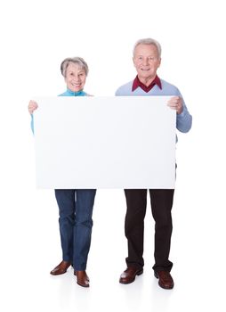 Happy Senior Couple Holding Blank Placard On White Background