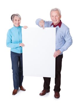 Happy Senior Couple Holding Blank Placard On White Background