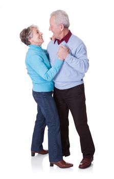 Portrait Of Senior Couple Dancing On White Background