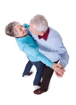 Portrait Of Senior Couple Dancing On White Background