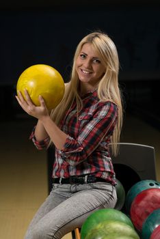 Women Holding A Bowling Ball