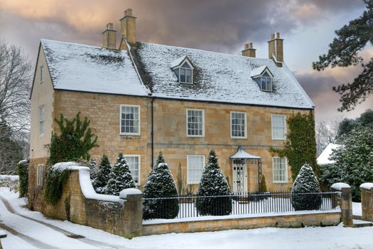 Detached Cotswold house with snow, Broadway, Worcestershire, England.