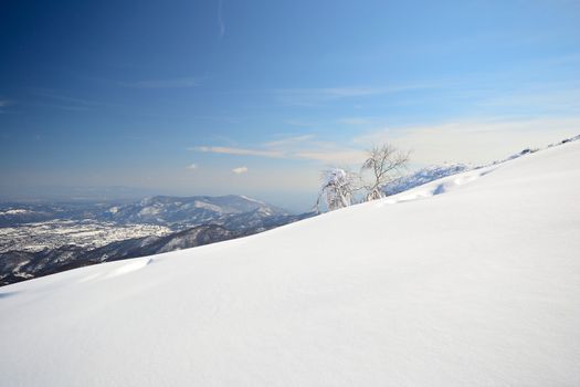 Candid off-piste ski slope in scenic background of high mountain peak