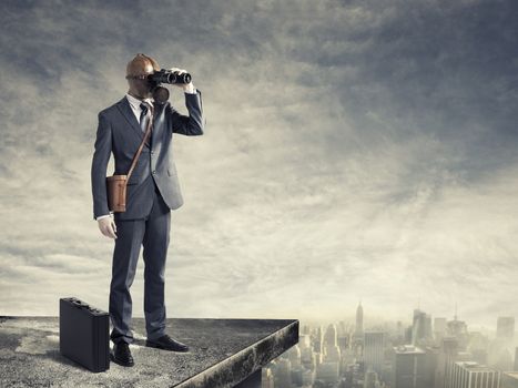 Businessman with gas mask looking through binoculars with a polluted city as background