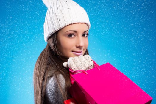 Beautiful young woman with her shopping bags