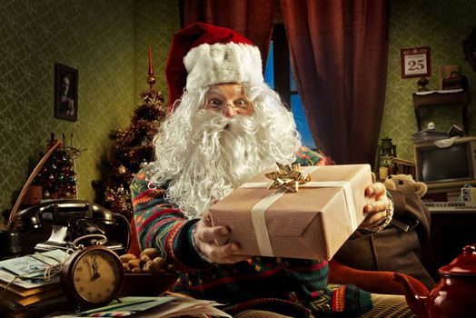 Portrait of Santa Claus holding a gift