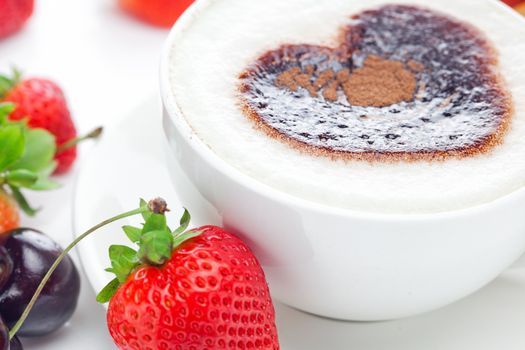 cappuccino in a cup in the shape of hearts,cherry,croissant  and strawberries isolated on white