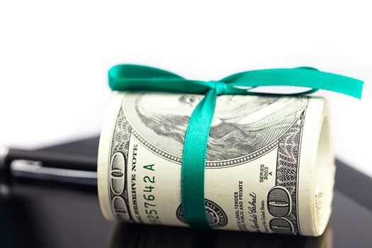 tablet,tube of dollars and stylus isolated on white