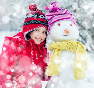 smiling little girl and snowman