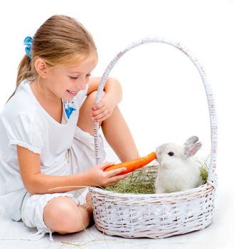 Cute Little girl with a rabbit in basket