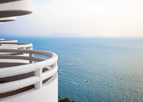 White, curved  balcony looking over beautiful blue ocean