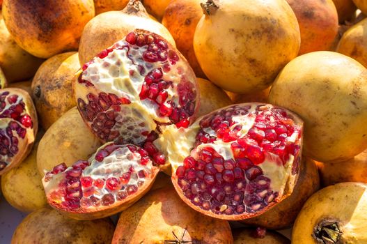 Full frame take of ripe pomegranates on display  at a market stall