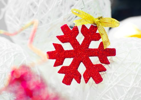 Red snowflake in the blurry background