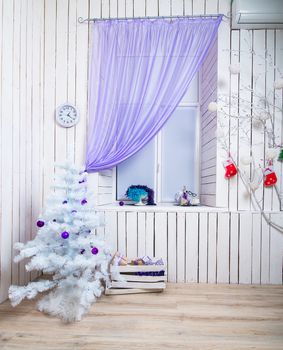 beautiful interior with white Christmas tree in lilac tones