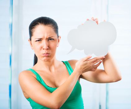 sulky young brunette woman holding a white cloud for text