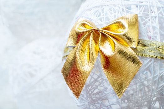 Gold Christmas bow on white Bell