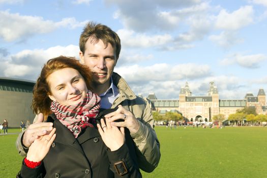 Outdoor happy couple in love, Museum Plein, autumn Amsterdam background