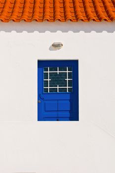 Wooden Door in the White Wall of Portuguese Home