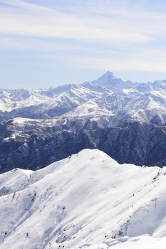 Candid off-piste ski slope in scenic background of high mountain peak