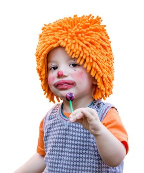 Portrait of cute clown child eating a lollipop isolated on white background
