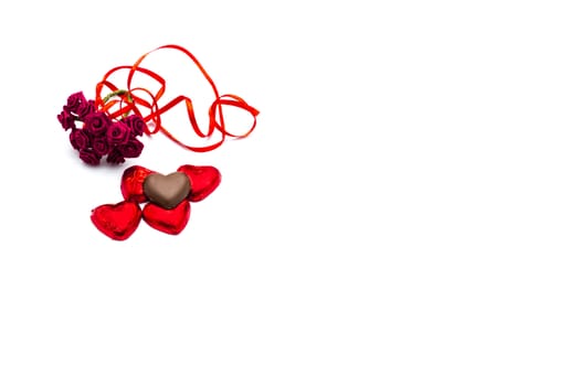 Chocolate and roses on white background for love and Valentines Day concept