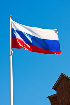 Russian flag on  background of blue sky